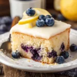 Lemon Blueberry Cake topped with fresh blueberries and lemon zest.